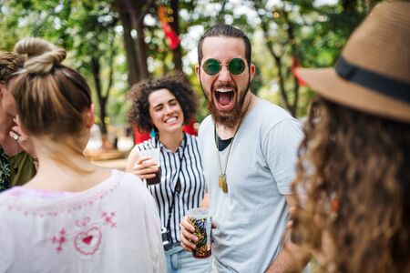 Group of young friends at summer festival, having good time.の写真素材