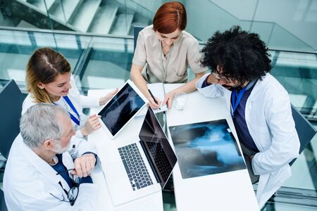 Group of doctors looking at X-ray on medical conference, discussing issues.