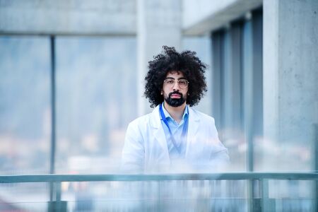 Portrait of male doctor standing in hospital. Copy space.
