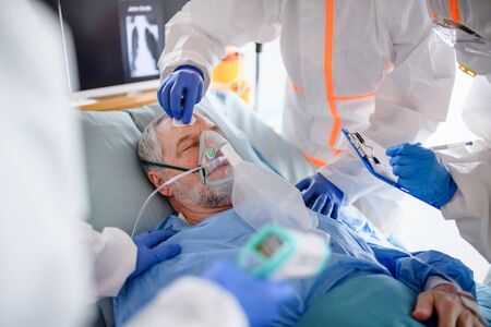 Infected patient in quarantine lying in bed in hospital, coronavirus concept.