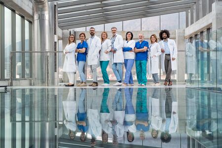 Group of doctors standing in corridor on medical conference.の写真素材