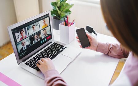 Unrecognizable young woman with tablet, online business call concept.の写真素材
