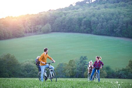 Family with two small children on cycling trip, having fun.の写真素材