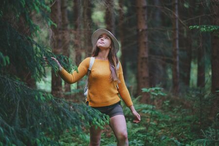 Young woman on a walk outdoors in forest in summer nature, walking.の写真素材