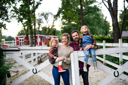 Portrait of family with small children standing on farm.の写真素材