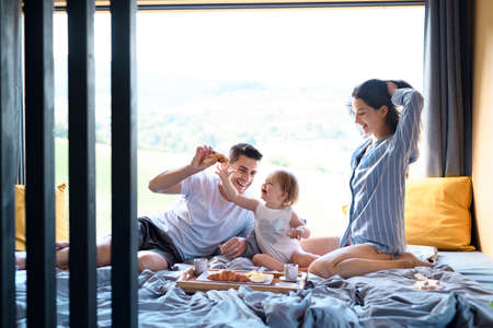 Young family with small daughter indoors, weekend away in container house in countryside.の写真素材