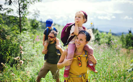 Family with small children hiking outdoors in summer nature.の写真素材