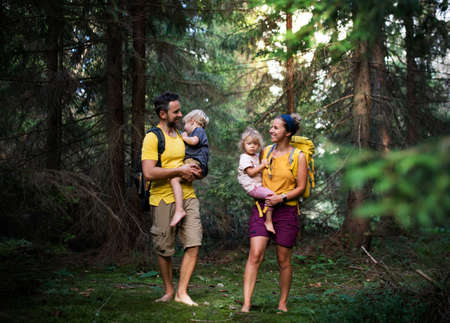 Family with small children walking barefoot outdoors in summer nature.の写真素材