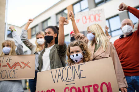 People with placards and posters on public demonstration, no covid vaccine concept.の写真素材