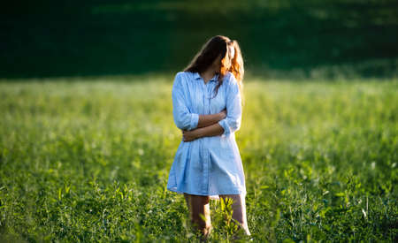 Portrait of young teenager girl outdoors in nature on meadow.の写真素材