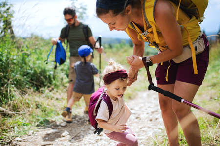 Family with upset small children hiking outdoors in summer nature.の写真素材