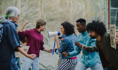 Group of people activists protesting on streets, strike, demonstration and fight concept.の写真素材