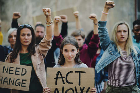 Group of people activists protesting on streets, strike and demonstration concept.