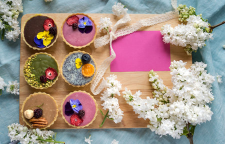 Top view of selection of colorful and delicious cake desserts in box on table. Copy space.の写真素材
