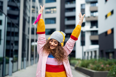 Young woman dancing outdoors on streetの写真素材