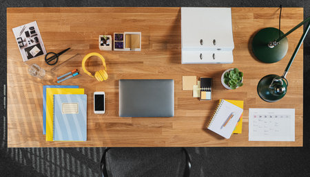 Top view of desk with computer, tablet and paperwork in home office.の写真素材