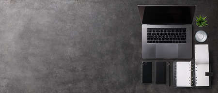 Flat lay top view office desk working space with laptop on gray background. Copy space.の写真素材