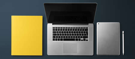 Flat lay top view office desk working space with laptop on dark background.の写真素材