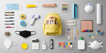 Flat lay top view of face mask and school supplies, back to school and virus concept.の写真素材