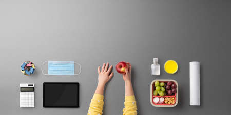 Flat lay top view of face mask and school supplies, back to school and coronavirus concept.の写真素材