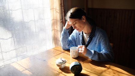 Portrait of unhappy poor mature woman indoors at home, poverty concept.の写真素材