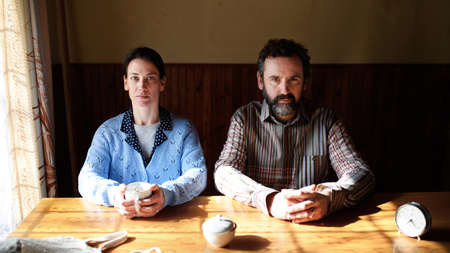 Portrait of poor mature couple indoors at home, poverty concept.の写真素材