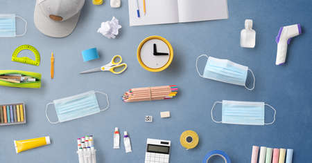 Flat lay top view of face mask and school supplies, back to school and concept.