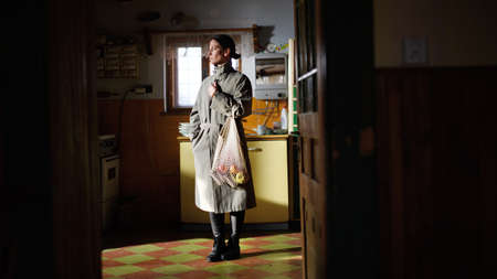 Portrait of poor mature woman with shopping indoors at home, poverty concept.の写真素材