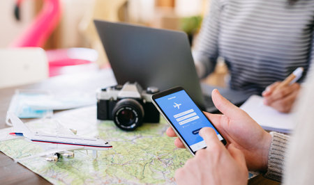 Unrecognizable couple with smartphone planning holiday
