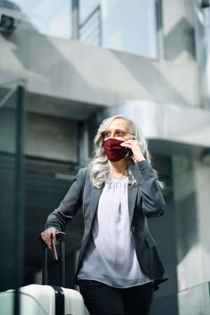 Senior woman in airport lounge,  travel and new normal.の写真素材