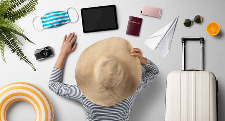 Flat lay top rear view of young woman, summer holiday, coronavirus, travel and new normal concept.の写真素材