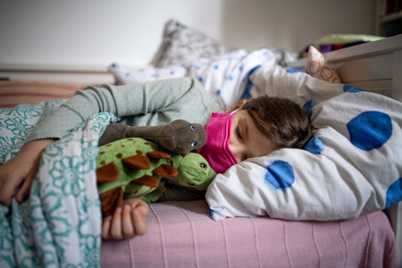 Sick small girl sleeping in bed at home, coronavirus concept.の写真素材