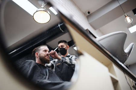 Man client visiting haidresser in barber shop, coronavirus and new normal concept.の写真素材