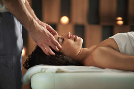 Young woman having head massage at the spa.の写真素材