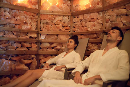 Portrait of young couple in salt inhalation steam room, relaxing.の写真素材