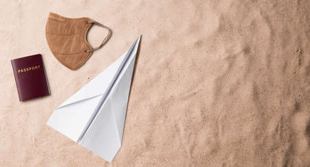 Flat lay top view of face mask and passport, summer holiday and travel concept.の写真素材