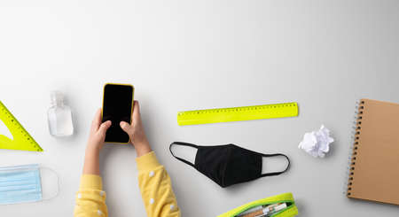 Flat lay top view of face mask and school supplies, back to school and coronavirus concept.