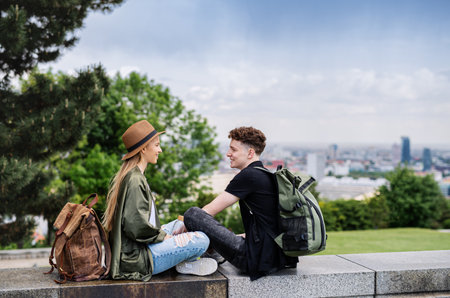 Young couple travelers with map in city on holiday, resting and planning.の写真素材