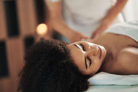 Young woman having massage at the spa, relaxing.