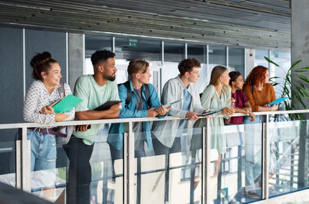 Group of university students standing indoors, back to school concept.