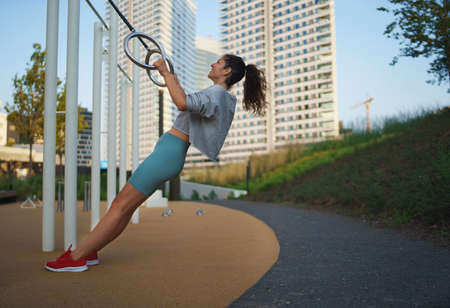 Mid adult woman doing exercise outdoors in city, healthy lifestyle concept.