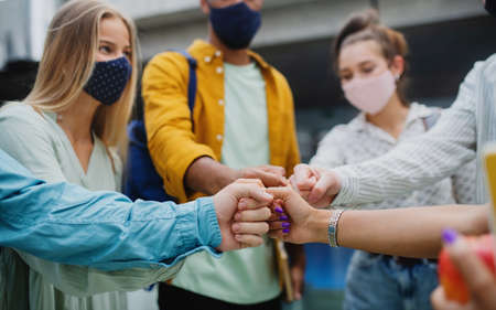 University students standing and greeting outdoors, coronavirus and back to normal concept.の写真素材