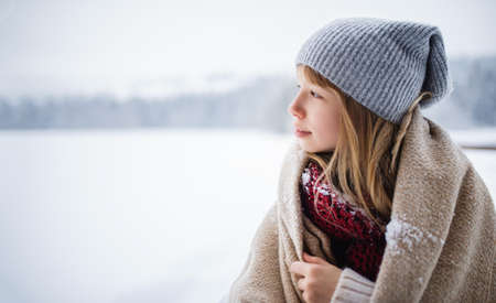 Portrait of preteen girl outdoors in winter nature, copy space.の写真素材