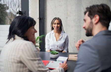 Happy young woman having job interview in office, business and career concept.