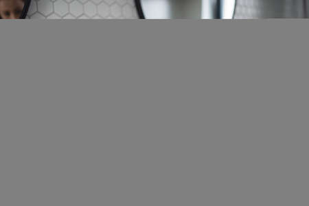 Unrecognizable mother with small daughter brushing teeth indoors in bathroom in the evening or morning.の写真素材