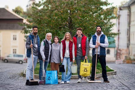 Group of happy volunteers looking at camera, ready to clean up street, community service conceptの写真素材