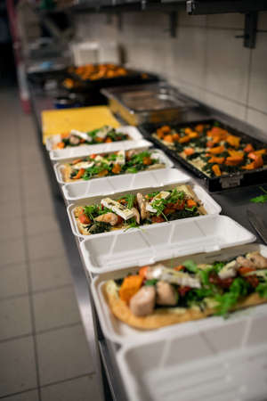 Meals in containers prepared for take away in kitchen restaurant.の写真素材