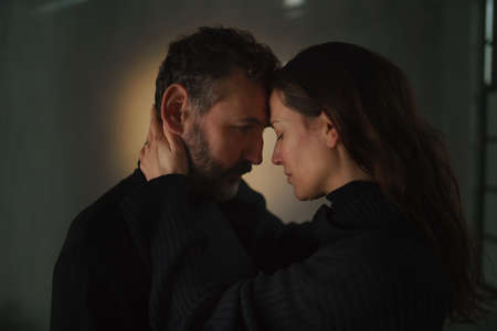 Loving husband apologizing and comforting sad wife, caring man consoling gently touching face of...