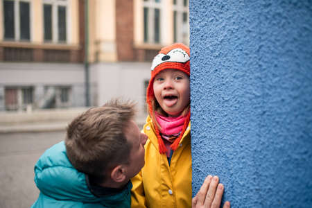 Father with his little daughter with Down syndrome outdoors in street in winterの写真素材