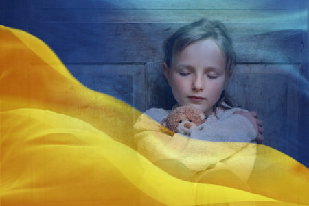 Double exposure of little girl refugee hodling teddy bear and Ukrainian flag.の写真素材